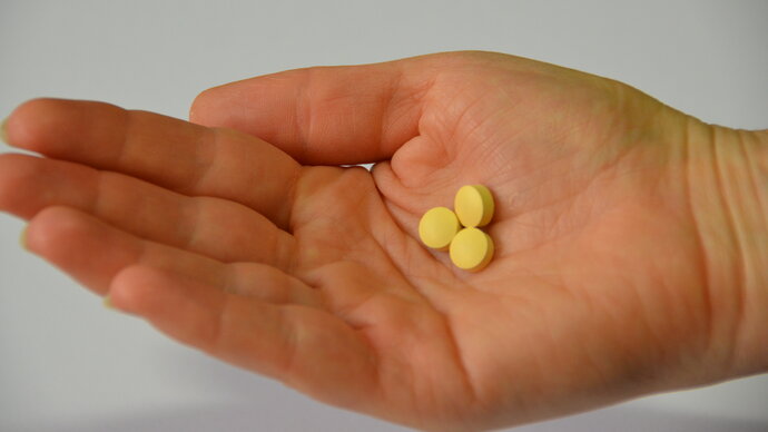 palm of hand face up holding dispersible tablets of tafenoquine