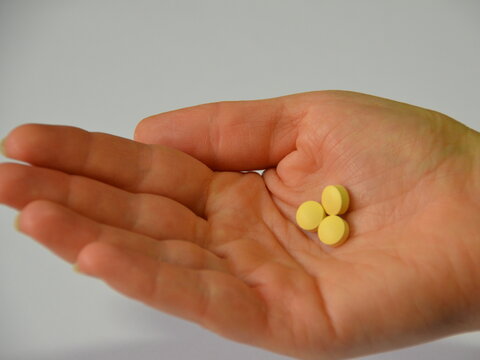 Palm of hand facing up holding 3 dispersible tablets of tafenoquine