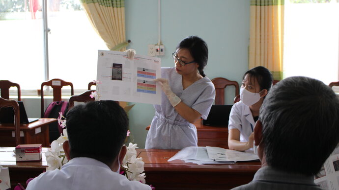 Woman conducting training session - showing materials to participants