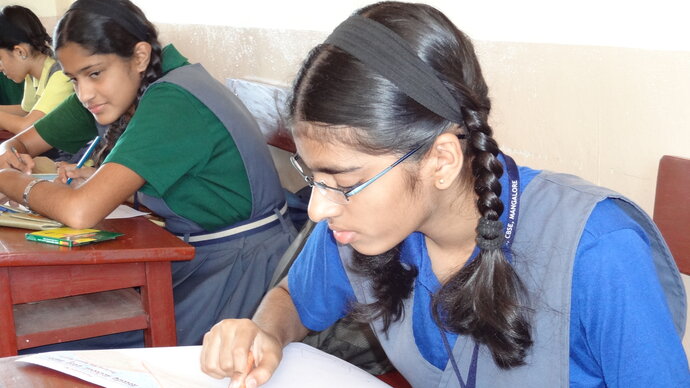 School girl writing at desk